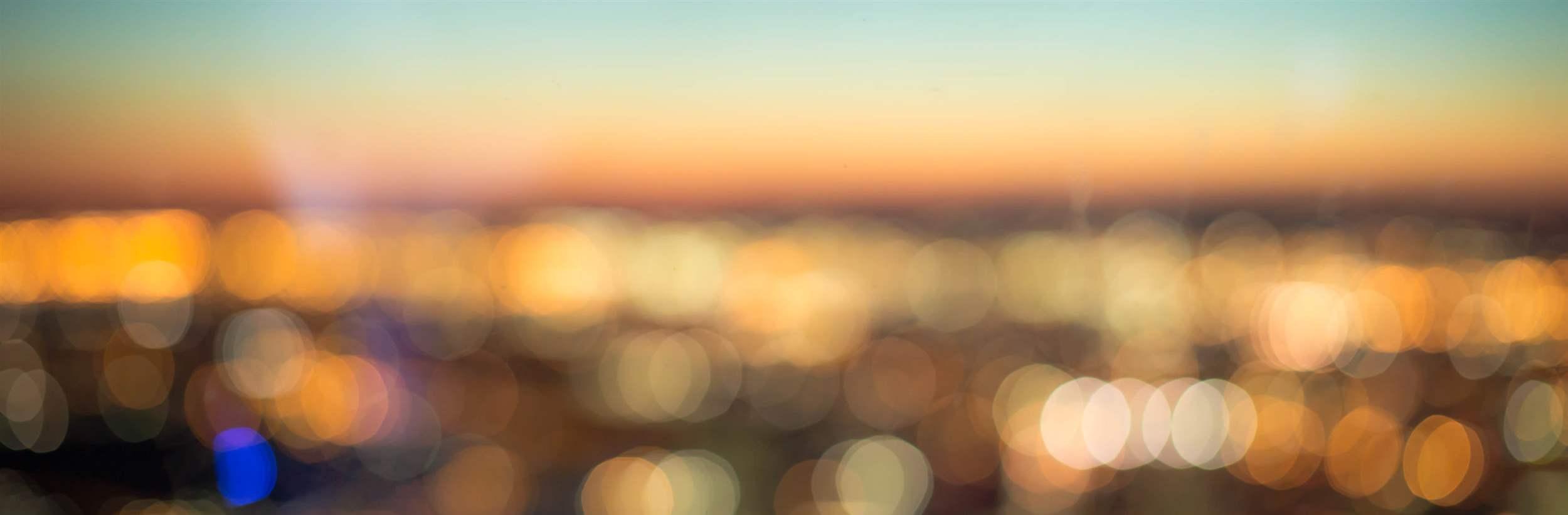 abstract blurred aerial view of sunset over city