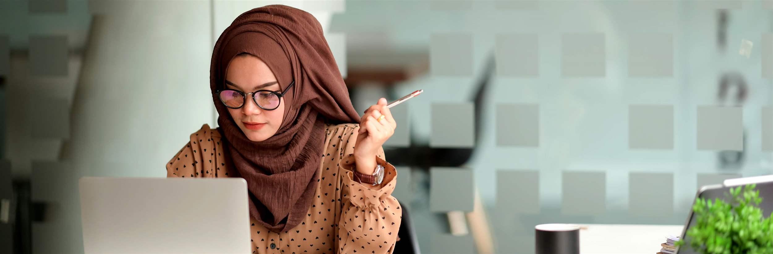 Attractive muslin woman working in office