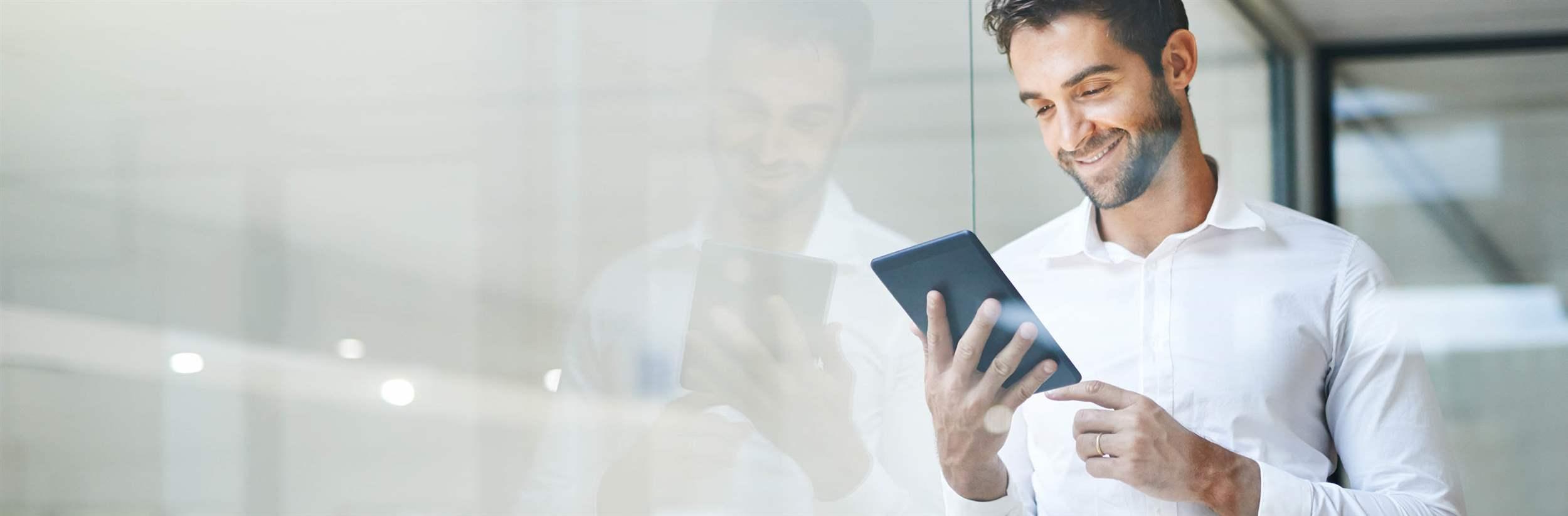 Cropped shot of a young businessman using a digital tablet in his office